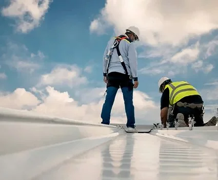 Roofing crew inspecting a commercial flat roof